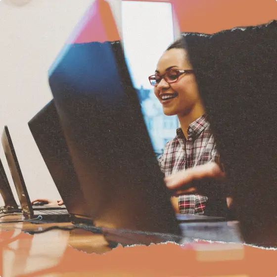 A girl working on a laptop computer at a desk
